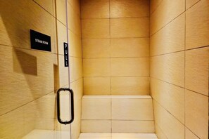 A steam room with tiled walls and a pull handle. - Queen Suites Tropicana The Residence by KLCC (Kuala Lumpur)