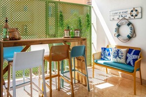 A dining area with a wooden table, chairs, and a green partition.
