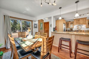 Una cocina moderna con armarios de madera, una isla central e iluminación colgante.