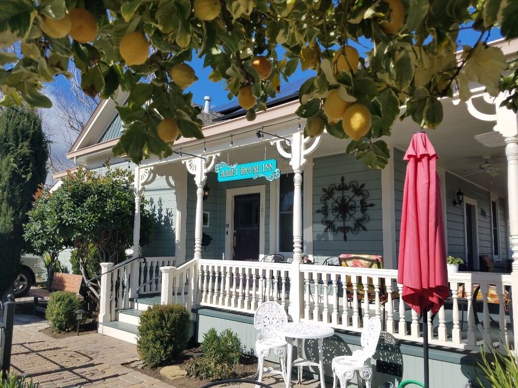 A house with a porch, white railing, and a sign that reads "JACK'S HOUSE".