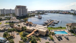 A hotel with a swimming pool, marina, and docked boats. - Sandpiper Cove 8249 Studio In Destin, FL  2-minute walk to the beach! (Destin)