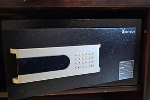 A black safe with a keypad and a logo on the top right. - Boutique Bravo Hotel (Pattaya)