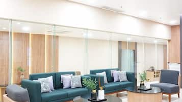 A modern waiting area with a sofa set, a coffee table, and a chair.
