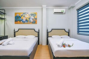 A room with two beds, a painting on the wall, an air conditioning unit, and a window with blinds. - Soho Premium Suites - Ben Thanh Market Area & SG's Heart (Ho Chi Minh City)