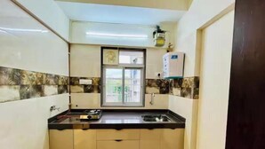 A small kitchen with a window, a sink, and a stove.