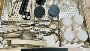 A drawer with kitchen utensils and containers, including knives, spoons, and measuring cups. - Executive 1BHK Suite | Near Link Road (Mumbai)