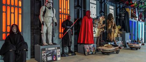 A display of Star Wars characters and vehicles in a museum setting.