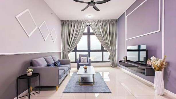 A modern living room with a grey sofa, a coffee table, a TV on a stand, and a ceiling fan. - Skudai Paradigm Mall by RR JBcity (Tebrau)
