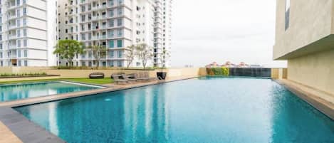 A swimming pool with a view of high-rise residential buildings.