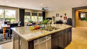 A modern kitchen with granite countertops, stainless steel appliances, and a large island. - 10 Mi to Temecula Old Town: Pet-Friendly Home (Murrieta)