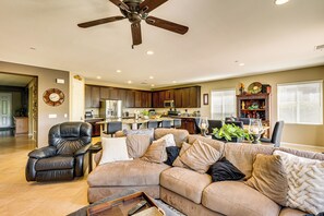 A spacious living room with a sectional sofa, a leather recliner, and a ceiling fan. - 10 Mi to Temecula Old Town: Pet-Friendly Home (Murrieta)