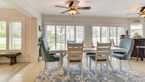A dining area with a table, chairs, and a ceiling fan. - Waterfront Largo Home w/ Canal Access + Boat Dock (Largo)