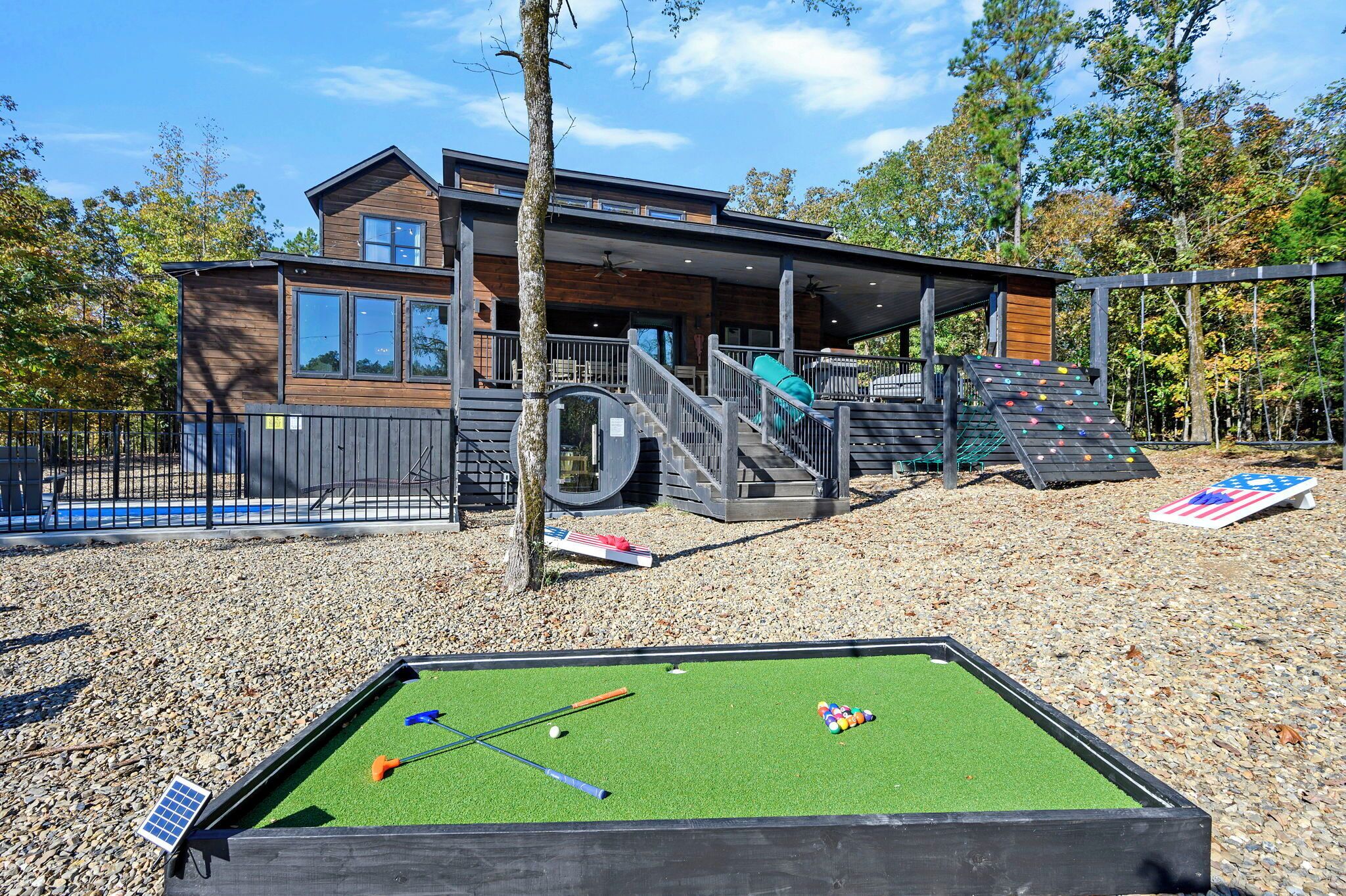 A modern building with a pool table and a climbing wall.