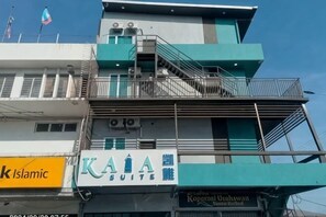 A hotel with a prominent sign for 'KAIA Suite' and a flag on top. - Kaia Suite Hotel (Semporna)