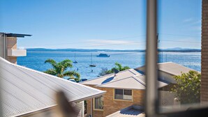 A residential area with houses, a view of the sea, and boats.