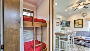 A bunk bed with a red mattress, a ceiling fan, and a dining area with a table and chairs. - A 100‑Acre Retreat for Gatherings of All Sizes (Pleasant Mount)
