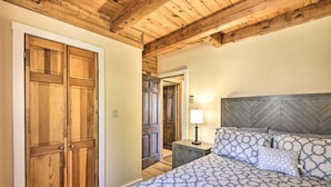 A bedroom with a bed, wooden wardrobe, and a nightstand with a lamp. - A 100‑Acre Retreat for Gatherings of All Sizes (Pleasant Mount)