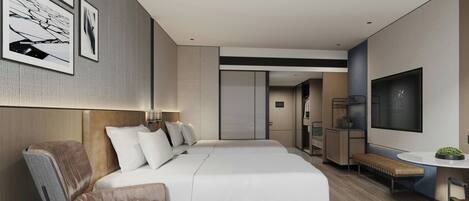A modern hotel room with a large bed, a seating area with a coffee table, and a TV on the wall.
