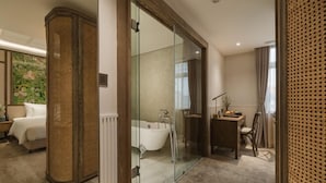 A modern bathroom with a glass shower enclosure, a white bathtub, and a wooden vanity. - La Passion Hanoi Hotel & Spa (Hanoi)