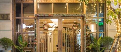 A hotel entrance with a sign reading "LA PASSION HOTEL".