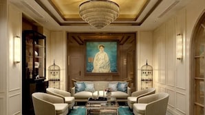 A spacious lounge with a large painting, comfortable seating, and a decorative chandelier. - La Passion Hanoi Hotel & Spa (Hanoi)