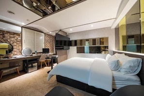 A modern bedroom with a bed, desk, and seating area. - Jamsil Louize (Seoul)