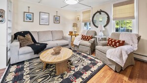 A living room with a sofa, armchairs, a coffee table, and a patterned rug. - Walk Downtown! SUNY, near Power Plants, Hospital, Pets. 3 bathrooms, King beds! (Oswego)
