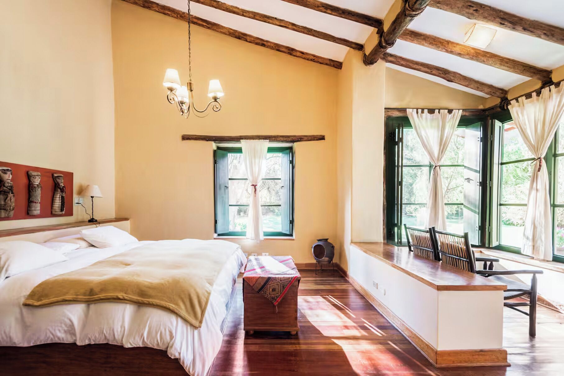 Une chambre à coucher avec un lit, un bureau et une fenêtre avec des rideaux.
