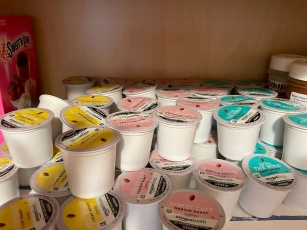 A collection of coffee containers with labels indicating different flavors and brands. - Hook, Relax & Stay: 3 BR Fishing Haven in Aransas Pass (Aransas Pass)