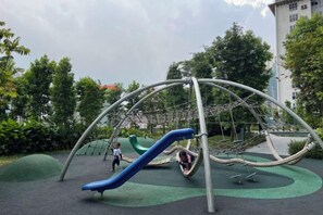 A playground with a slide and climbing structures. - Agile Bukit Bintang Suites at TRX KL (Kuala Lumpur)
