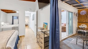 Quarto moderno com cama, escrivaninha e vista para o exterior.