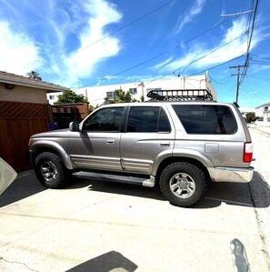 A silver SUV parked on a residential street.