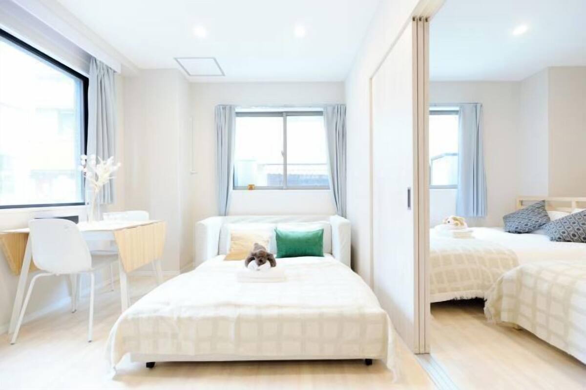 A modern hotel room with a large bed, a desk, and a chair.