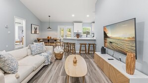 A modern living room with a sofa, coffee table, and TV.