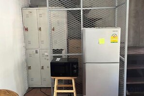 A kitchenette with a refrigerator, microwave, and cabinets. - Siam Breeze Inn (Self check-in) (Bangkok)