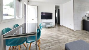 A modern kitchen with white cabinets, a microwave, and a small countertop. - Stunning home in Turís (Turís)