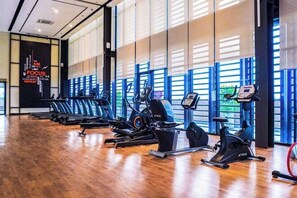 A gym with exercise equipment, large windows, and a motivational quote on the wall. - Forte Seasons Mossaz Premium Suites Petaling Jaya by BYON (Petaling Jaya)