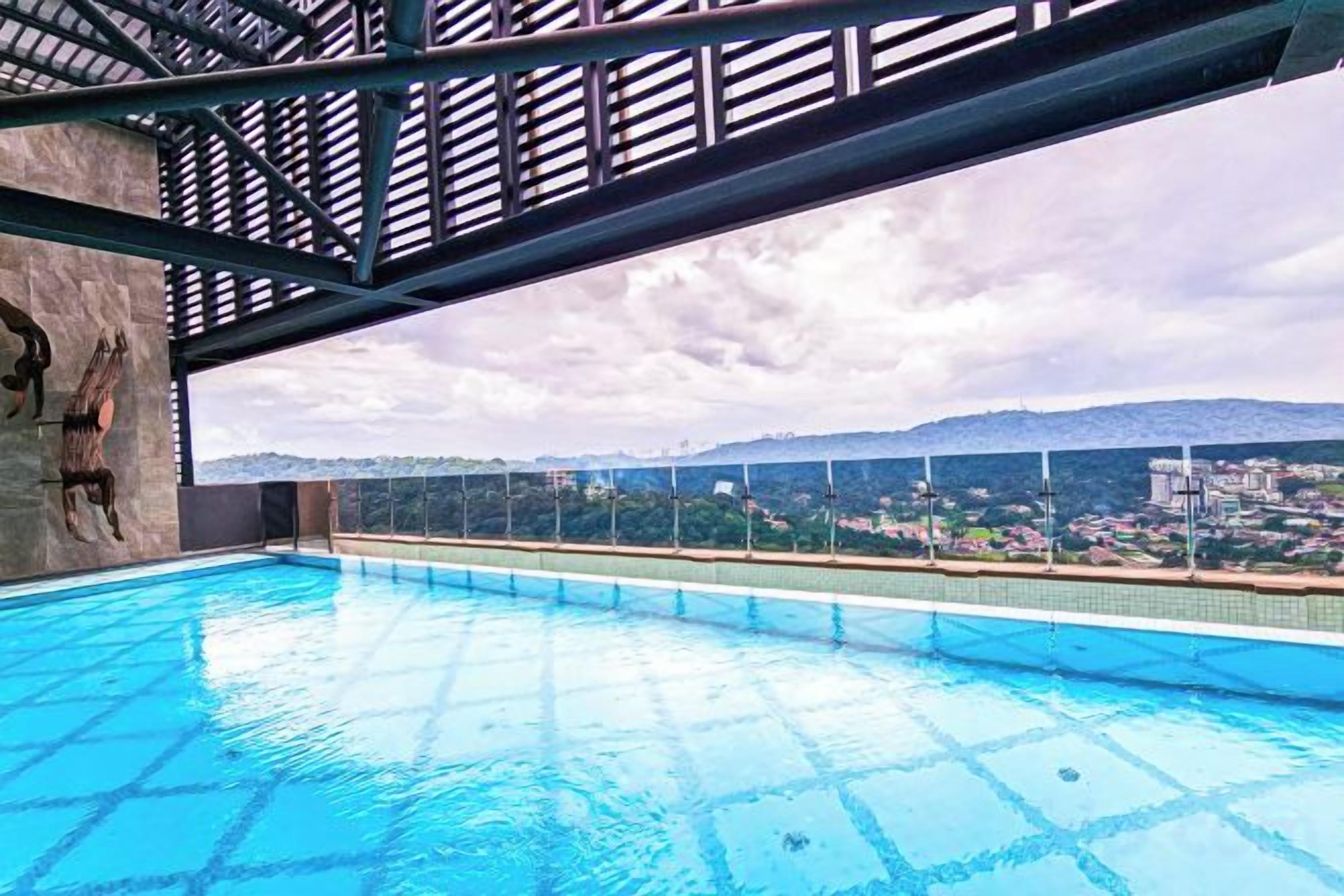 A swimming pool with a view of a cityscape and mountains.