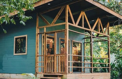 Surfside tiny home with modern amenities like AC, modern design, bathtub,and TV.