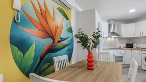 Una cocina moderna con armarios blancos, un microondas y un lavamanos.