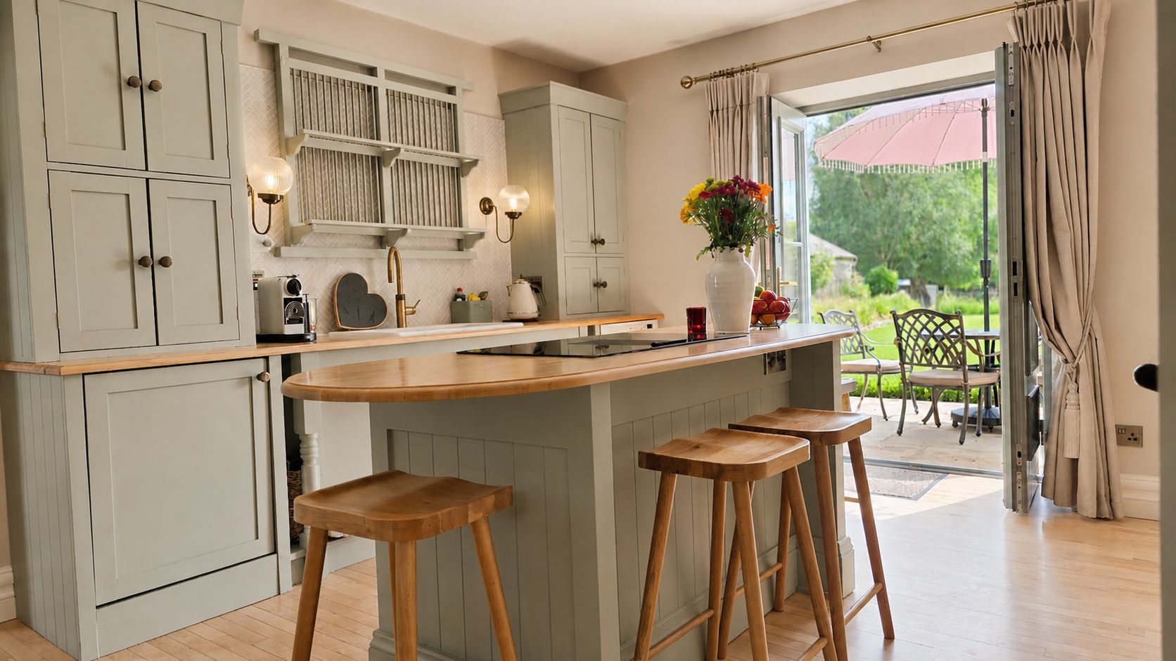 A kitchen with a central island, bar stools, and a view to the outside.