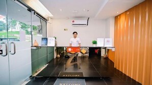 A reception area with a welcome mat, a reception desk, a chair, and a potted plant. - Swing & Pillows @ Central Market Kuala Lumpur (Kuala Lumpur)