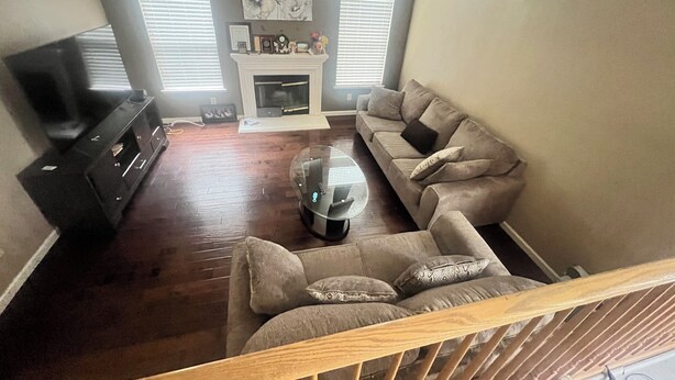 A living room with a fireplace, a sofa, a coffee table, and a TV. - House with AC in Elk Grove (Elk Grove)