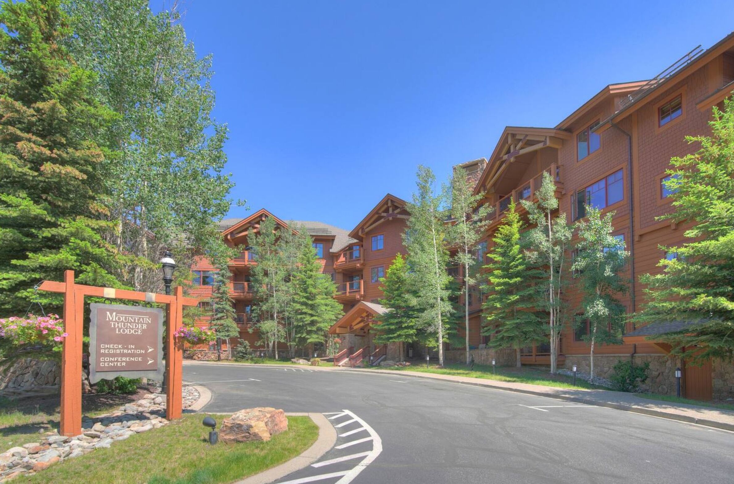 A lodge with a sign indicating Mountain Thunder Lodge and a conference center.