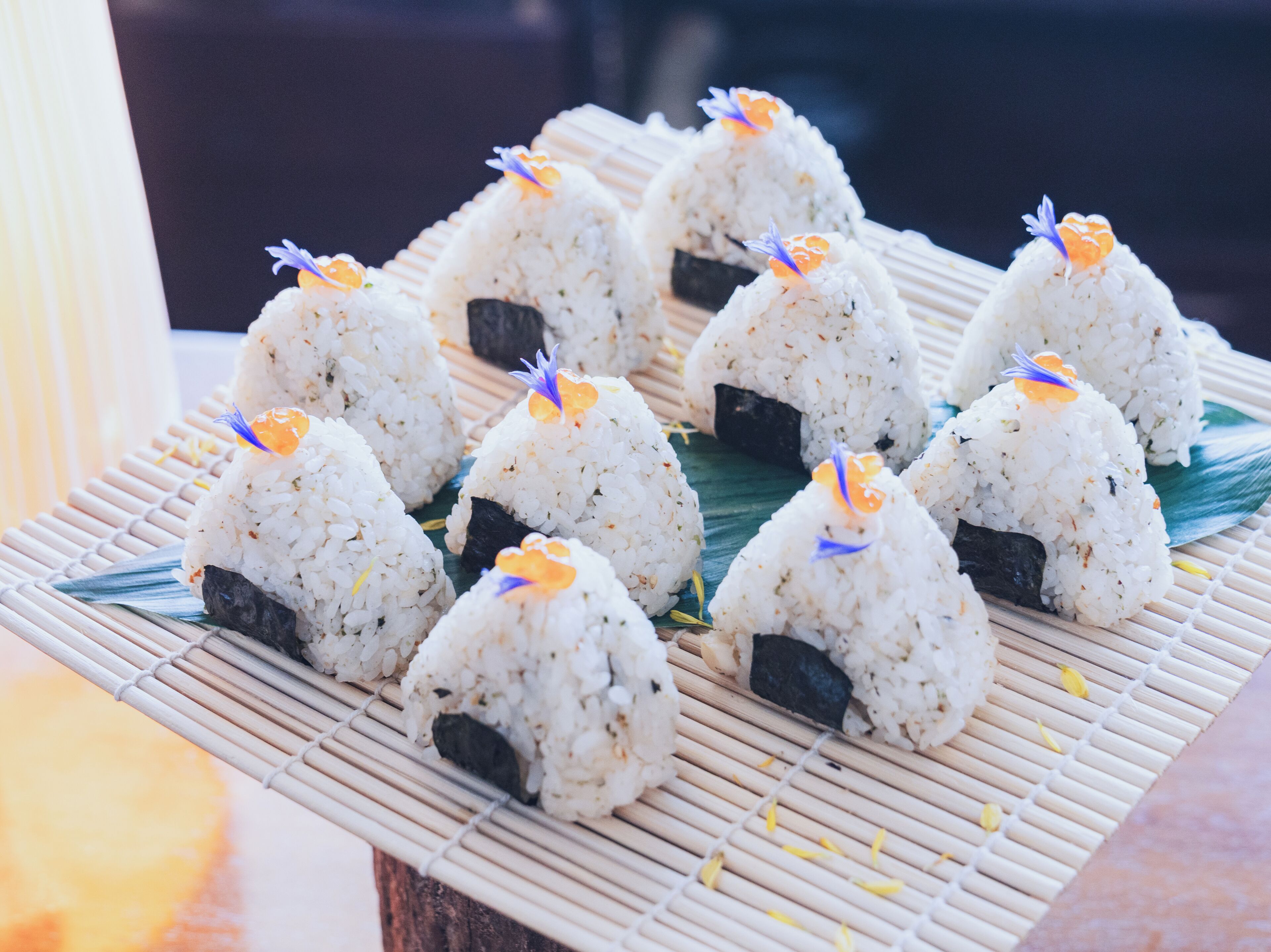 A tray of sushi with decorative elements.