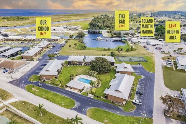 An aerial view of a residential area with marked locations for 'Our Condo Here', 'TIKI BAR Here', 'ROLAND MARTIN MARINA', and 'Live Weigh In Area'.
