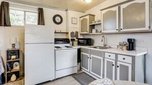 A compact kitchen with a refrigerator, stove, microwave, and sink. - Fish, Boat & Hike: Norfork Lake Studio Near Marina (Mountain Home)
