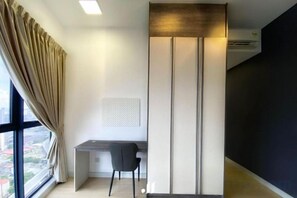 A modern office space with a desk, chair, and a large window with curtains. - Continew Residence by Janice's Homestay (Kuala Lumpur)