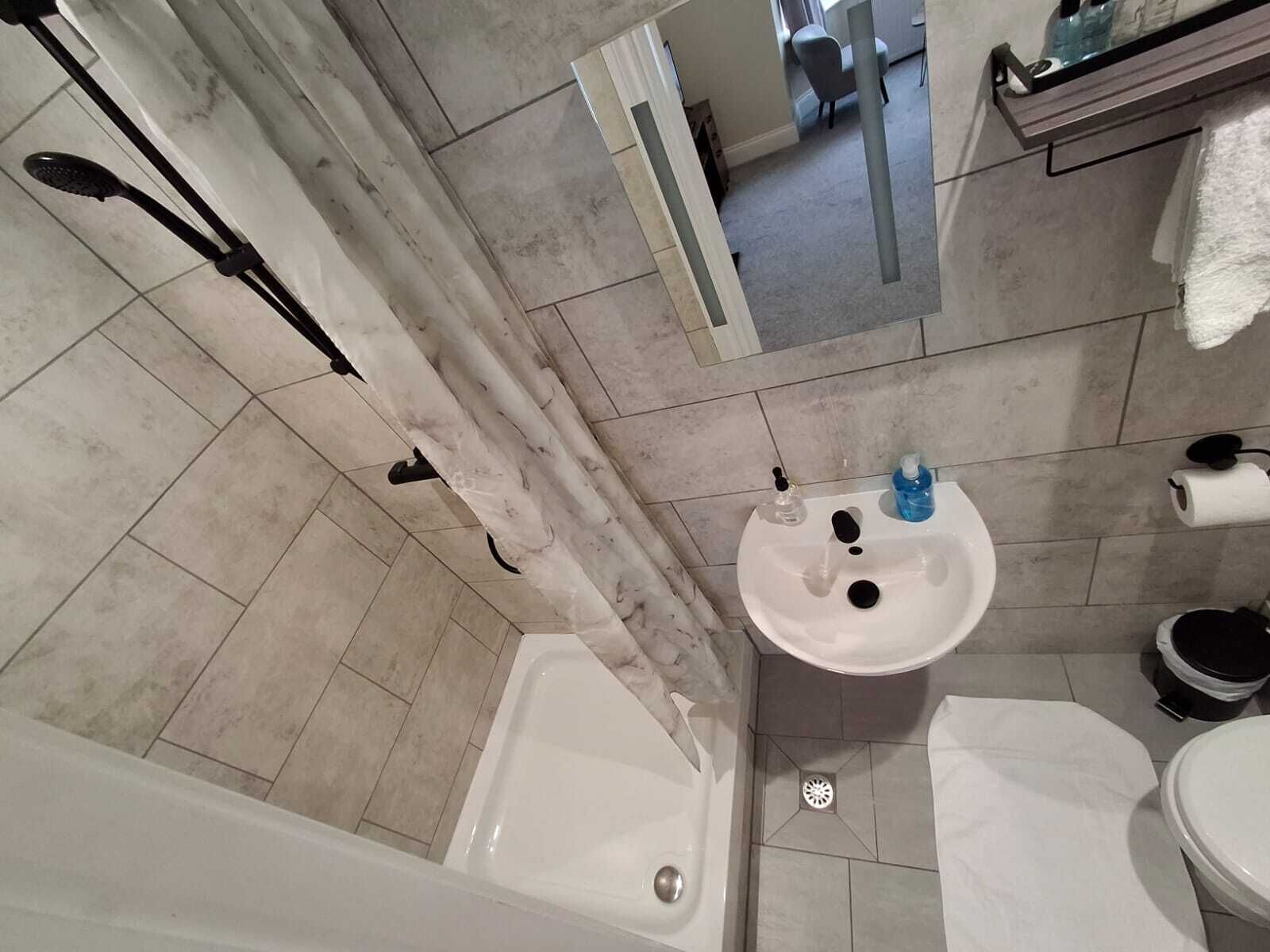 A bathroom with a bathtub, sink, and toilet.