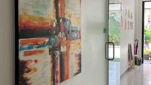 A hallway with a large abstract painting on the wall, a glass door, and a tiled floor. - Kata Lovely Rest Bed and Breakfast (Phuket)